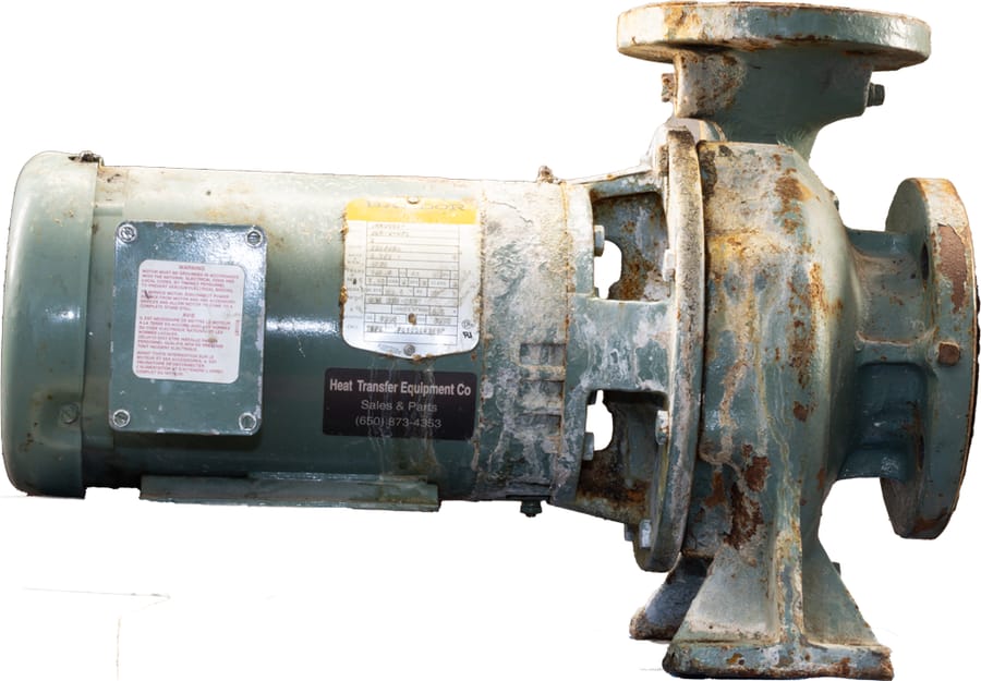 A rusty, corroded centrifugal pump on white before rebuild