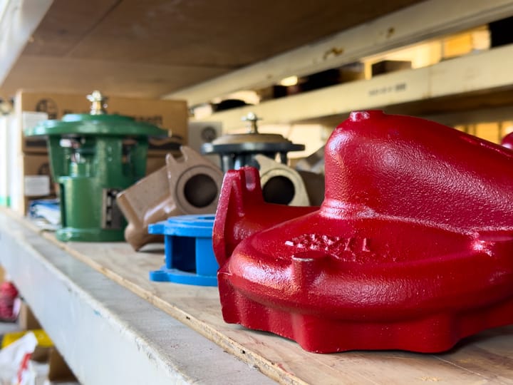 Freshly rebuilt and repainted pump castings on a shop shelf